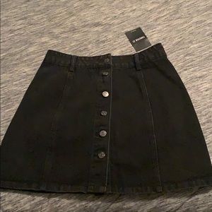 Black denim button down skirt.